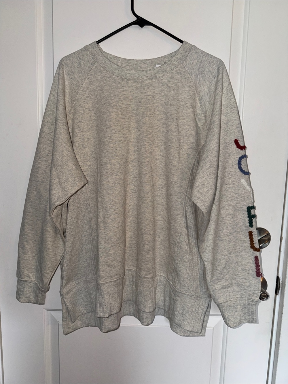 Heather Gray Sweatshirt with Multicolor Sleeve Embroidery that reads “JOYFUL”